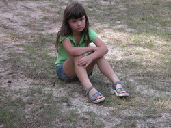 PSad, lonely child sitting on grass