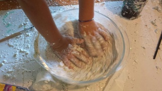 Sensory Activity Child's hand in shaving cream and cornstarch